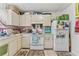 A functional kitchen with white appliances and cabinets that has plenty of storage space at 2840 Somerset Park Dr # 203, Tampa, FL 33613