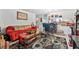 Cozy living room features a red couch, decorative rug, and counter overlooking the kitchen at 2840 Somerset Park Dr # 203, Tampa, FL 33613