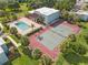 Aerial view of pool and tennis court with manicured landscaping and inviting recreation area at 2840 Somerset Park Dr # 203, Tampa, FL 33613