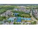 Aerial view of a community featuring townhomes, lush landscaping, ponds, and recreation areas for an active lifestyle at 30140 Barnaby Ln, Wesley Chapel, FL 33543