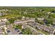 Overhead view of tan townhomes with well-kept lawns, providing a picturesque and inviting neighborhood setting at 30140 Barnaby Ln, Wesley Chapel, FL 33543