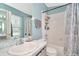 Bathroom with a single sink vanity, tub/shower combo and tile flooring at 30140 Barnaby Ln, Wesley Chapel, FL 33543