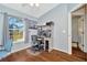 Bright room featuring hardwood floors, a work area, and a large sunny window at 30140 Barnaby Ln, Wesley Chapel, FL 33543