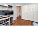 Bedroom featuring hardwood floors, a workspace, and double door closet at 30140 Barnaby Ln, Wesley Chapel, FL 33543