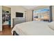 Bedroom features hardwood floors, dresser, television and closet at 30140 Barnaby Ln, Wesley Chapel, FL 33543