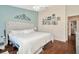 This bedroom has a large decorative headboard, hardwood floors, and a ceiling fan at 30140 Barnaby Ln, Wesley Chapel, FL 33543