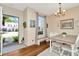 Cozy dining area with wood floors and view of the front yard at 30140 Barnaby Ln, Wesley Chapel, FL 33543