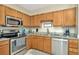 Updated kitchen with stainless steel appliances, granite counters and ample cabinet space at 30140 Barnaby Ln, Wesley Chapel, FL 33543