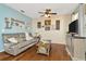 Bright living room with wood floors, comfortable sofa, and stylish decor at 30140 Barnaby Ln, Wesley Chapel, FL 33543