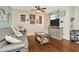 Inviting living room featuring wood floors, stylish decor, and a comfortable sofa at 30140 Barnaby Ln, Wesley Chapel, FL 33543