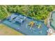 Aerial view of a vibrant playground and sunshades, set amidst lush greenery at 30140 Barnaby Ln, Wesley Chapel, FL 33543