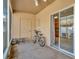 Screened porch with tile flooring, door to the outside, and sliding door to the laundry room at 30140 Barnaby Ln, Wesley Chapel, FL 33543