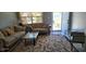 Comfortable living room with neutral tones, plush sofas, and a glass coffee table at 3026 19Th Sw Pl, Largo, FL 33774