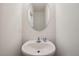 Small white bathroom with sink and mirror at 32965 Kaloko Rd, Wesley Chapel, FL 33543