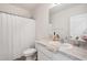 Bathroom featuring a toilet, shower, and a vanity with ample storage space at 32965 Kaloko Rd, Wesley Chapel, FL 33543