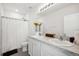 Bathroom showcasing a double sink vanity, a toilet, and a shower with a white curtain at 32965 Kaloko Rd, Wesley Chapel, FL 33543