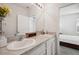 Bathroom featuring a double sink vanity and a large mirror, perfect for a growing Gathering at 32965 Kaloko Rd, Wesley Chapel, FL 33543