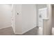 Hallway with grey tile flooring and white walls and trim at 32965 Kaloko Rd, Wesley Chapel, FL 33543