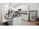 Modern open kitchen with granite countertops, stainless steel appliances, and white cabinetry at 32965 Kaloko Rd, Wesley Chapel, FL 33543