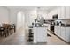 Bright kitchen with a granite countertop island and white cabinetry at 32965 Kaloko Rd, Wesley Chapel, FL 33543