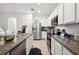 Stainless steel appliances and granite countertops complement the white cabinetry at 32965 Kaloko Rd, Wesley Chapel, FL 33543