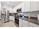 Kitchen with stainless steel appliances and white cabinetry at 32965 Kaloko Rd, Wesley Chapel, FL 33543
