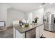 Kitchen island with stainless steel dishwasher and sink with granite countertops at 32965 Kaloko Rd, Wesley Chapel, FL 33543
