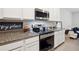 Modern kitchen with stainless steel stove, microwave and granite countertops at 32965 Kaloko Rd, Wesley Chapel, FL 33543