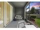 Enclosed patio with outdoor seating, sliding glass door and view of the lawn and neighborhood at 32965 Kaloko Rd, Wesley Chapel, FL 33543