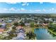 Aerial view of homes, neighborhood, and scenic pond surrounded by lush landscaping at 3330 46Th E Ter, Bradenton, FL 34203