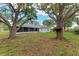 Lush backyard with mature trees providing ample shade for outdoor enjoyment at 3330 46Th E Ter, Bradenton, FL 34203