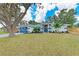 Beautiful single-story home featuring a well-manicured lawn, complemented by mature trees and decorative landscaping at 3330 46Th E Ter, Bradenton, FL 34203