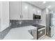 Modern kitchen with light countertops, stainless appliances and mosaic backsplash at 3330 46Th E Ter, Bradenton, FL 34203