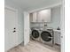 Bright laundry room features modern washer, dryer, and cabinets for organized storage at 3330 46Th E Ter, Bradenton, FL 34203