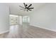 Open-concept living area featuring new wood-look floors, ceiling fan, and great natural light at 3330 46Th E Ter, Bradenton, FL 34203