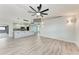Bright living room with ceiling fan and a view of the modern kitchen at 3330 46Th E Ter, Bradenton, FL 34203