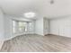 Spacious living room with wood-look floors, bay window, and neutral paint at 3330 46Th E Ter, Bradenton, FL 34203