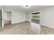 Living room with wood-look flooring, ceiling fan, and screened patio access at 3330 46Th E Ter, Bradenton, FL 34203