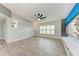 Open living room with lots of light, ceiling fan and large television at 3330 46Th E Ter, Bradenton, FL 34203