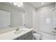 Well-lit bathroom with a gray vanity, quartz counters, and a shower-tub combo at 35609 Stableton Lane, Zephyrhills, FL 33541