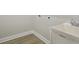 Bright laundry room featuring durable wood-look flooring and a utility sink for added convenience at 35609 Stableton Lane, Zephyrhills, FL 33541
