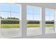 Three windows offering natural light and views of the surrounding greenery at 35609 Stableton Lane, Zephyrhills, FL 33541