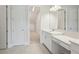 Bathroom with white cabinets, double vanity, stone countertop, and tile flooring at 35617 Stableton Lane, Zephyrhills, FL 33541