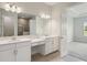 Bathroom featuring double sink vanity with white cabinets and stone countertop at 35617 Stableton Lane, Zephyrhills, FL 33541