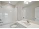 Bright bathroom featuring a white vanity, sink, shower and tub at 35617 Stableton Lane, Zephyrhills, FL 33541