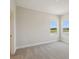 Bedroom with two windows with a view and neutral colored walls at 35617 Stableton Lane, Zephyrhills, FL 33541