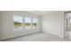 Bright bedroom with carpet and three windows overlooking outdoor space at 35617 Stableton Lane, Zephyrhills, FL 33541