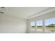 Bedroom featuring three windows offering a view of a green space and pond at 35617 Stableton Lane, Zephyrhills, FL 33541