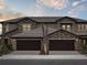 Beautiful townhomes featuring a brick facade, dark brown roofs, and two-car garages in a residential setting at 35617 Stableton Lane, Zephyrhills, FL 33541