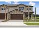 Two-story home featuring a brown roof and a two-car garage at 35617 Stableton Lane, Zephyrhills, FL 33541